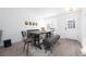 Bright dining room with wood table, seating for six, modern light fixture, and light wood flooring at 4485 E Andover Ave, Castle Rock, CO 80104