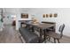 Open-concept dining room featuring a decorative fireplace, adjacent to a dining area with modern decor at 4485 E Andover Ave, Castle Rock, CO 80104