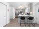 Open-concept kitchen with stainless steel appliances, breakfast bar, and modern light fixtures at 4485 E Andover Ave, Castle Rock, CO 80104