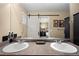 Bathroom features double sinks, modern vanity, and a sliding barn door at 6267 N Dunkirk Ct, Aurora, CO 80019