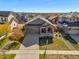 Single Gathering home with a well-manicured lawn, attached two-car garage, and welcoming front porch at 6267 N Dunkirk Ct, Aurora, CO 80019