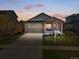Charming single-Gathering home featuring a brick porch, two-car garage, and well-maintained landscaping at 6267 N Dunkirk Ct, Aurora, CO 80019