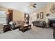 Comfortable living room features neutral walls, vaulted ceiling, ceiling fan, fireplace, and plush seating at 6267 N Dunkirk Ct, Aurora, CO 80019