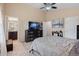 Spacious main bedroom featuring neutral walls, TV, ceiling fan, and ensuite bathroom access at 6267 N Dunkirk Ct, Aurora, CO 80019