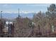 Scenic mountain view with snow-capped peaks, seen beyond a wooded fence and houses, offering a beautiful natural backdrop at 6267 N Dunkirk Ct, Aurora, CO 80019