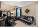 Office showing dark-colored furniture, a window with curtains, and a sofa at 6267 N Dunkirk Ct, Aurora, CO 80019