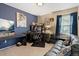 Office featuring blue accent walls, and an ample workstation plus sofa at 6267 N Dunkirk Ct, Aurora, CO 80019