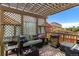 Charming covered patio with cozy seating, decorative curtains, and a lovely pergola, ideal for enjoying outdoor moments at 6267 N Dunkirk Ct, Aurora, CO 80019