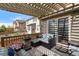 Relaxing patio area with cushioned seating, a stone fire pit, and sliding glass doors for seamless indoor-outdoor living at 6267 N Dunkirk Ct, Aurora, CO 80019