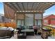 Outdoor patio featuring a grill, comfortable furniture, decorative curtains, and an overhead pergola for shaded enjoyment at 6267 N Dunkirk Ct, Aurora, CO 80019