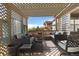 Inviting covered patio features comfortable seating and an open trellis, perfect for outdoor relaxation and entertaining at 6267 N Dunkirk Ct, Aurora, CO 80019