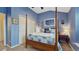 Bright bedroom featuring blue walls, a four poster bed, and carpeted floors at 16184 Gold Creek Dr, Monument, CO 80132