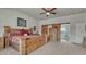 Spacious bedroom with bed, wooden accents, and sliding barn door leading to the bathroom at 16184 Gold Creek Dr, Monument, CO 80132