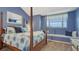 Blue bedroom featuring a four-poster bed, window seat, and plenty of natural light at 16184 Gold Creek Dr, Monument, CO 80132