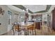 Inviting dining area showcasing modern lighting, hardwood floors, and a view to the kitchen at 16184 Gold Creek Dr, Monument, CO 80132