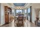 Elegant dining room with tray ceiling, a wooden table and decor at 16184 Gold Creek Dr, Monument, CO 80132
