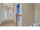Hallway featuring carpet flooring, white walls, and a wooden handrail at 16184 Gold Creek Dr, Monument, CO 80132