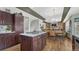 Open kitchen view to dining area showcasing the granite island with cooktop and wood flooring at 16184 Gold Creek Dr, Monument, CO 80132