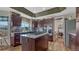 Modern kitchen with dark wood cabinets, granite countertops, and stainless steel appliances at 16184 Gold Creek Dr, Monument, CO 80132