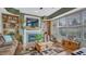 Comfortable living room featuring a fireplace, built-in shelving, and plenty of natural light at 16184 Gold Creek Dr, Monument, CO 80132
