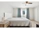 Main bedroom with ceiling fan, window, and grey carpet at 9044 W 63Rd Ave, Arvada, CO 80004