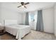Main bedroom with ceiling fan, window, and grey carpet at 9044 W 63Rd Ave, Arvada, CO 80004