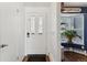 Inviting entryway with white door and wood flooring at 9044 W 63Rd Ave, Arvada, CO 80004