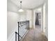 Upper hallway with carpet, black railing, and bedroom access at 9044 W 63Rd Ave, Arvada, CO 80004