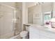 Light-filled bathroom featuring glass shower enclosure, generous counterspace, and plentiful cabinets at 335 Josephine St # D, Denver, CO 80206