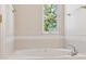 Relaxing soaking tub next to a window, offering natural light and a peaceful view at 335 Josephine St # D, Denver, CO 80206