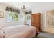 Cozy bedroom with closet and dresser, with two large windows providing ample natural light at 335 Josephine St # D, Denver, CO 80206