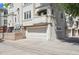 Exterior view of a townhome featuring an attached garage and a small balcony with decorative planters at 335 Josephine St # D, Denver, CO 80206
