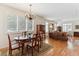 Open living room with hardwood floors, plantation shutters, chandelier and lovely traditional furnishings at 335 Josephine St # D, Denver, CO 80206