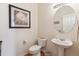 Charming powder room featuring a pedestal sink, decorative mirror and stylish wall art at 335 Josephine St # D, Denver, CO 80206