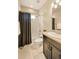 Bright bathroom features tiled shower-tub, neutral walls and dark vanity with granite countertop at 18175 W 94Th Ave, Arvada, CO 80007