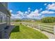 Beautiful backyard featuring a lush green lawn, white fence, and scenic mountain views at 1842 Peak Prairie Ln, Monument, CO 80132