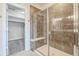 Beautiful walk-in shower with glass door, bench and access to walk-in closet at 1842 Peak Prairie Ln, Monument, CO 80132