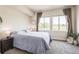 Serene bedroom featuring large windows, plush bedding, and ample natural light at 1842 Peak Prairie Ln, Monument, CO 80132