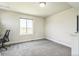 Bright bedroom with large window, neutral walls, and view of neighborhood at 1842 Peak Prairie Ln, Monument, CO 80132