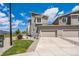 Well-maintained home with a garage, complemented by green grass, and landscaping at 1842 Peak Prairie Ln, Monument, CO 80132