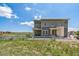 Beautiful exterior shot of property with white fence, grass and blue skies at 1842 Peak Prairie Ln, Monument, CO 80132