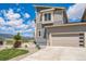 Exterior view of home featuring a two-car garage and mountain views at 1842 Peak Prairie Ln, Monument, CO 80132