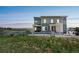 Modern two-story home featuring an inviting exterior with a cozy porch, neutral siding, and manicured landscaping at 1842 Peak Prairie Ln, Monument, CO 80132
