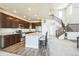 Well-lit kitchen with dark cabinets, stainless steel appliances, and a center island with seating at 1842 Peak Prairie Ln, Monument, CO 80132