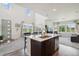 Bright open kitchen with a quartz island, stainless appliances, and views of the backyard at 1842 Peak Prairie Ln, Monument, CO 80132