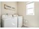 Laundry room with front loading washer and dryer and a window at 1842 Peak Prairie Ln, Monument, CO 80132