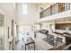 Open-concept living space with tall ceilings, large windows, and a seamless flow to the dining area and kitchen at 1842 Peak Prairie Ln, Monument, CO 80132