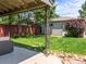 Covered backyard patio with stylish furniture set, overlooking the lush green lawn and garden, creating an inviting retreat at 4250 Wyandot St, Denver, CO 80211