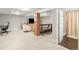 Finished basement featuring a modern living area and a brick support beam at 4250 Wyandot St, Denver, CO 80211