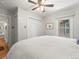 This bedroom is light and bright and features a ceiling fan and spacious white closets for storage at 4250 Wyandot St, Denver, CO 80211